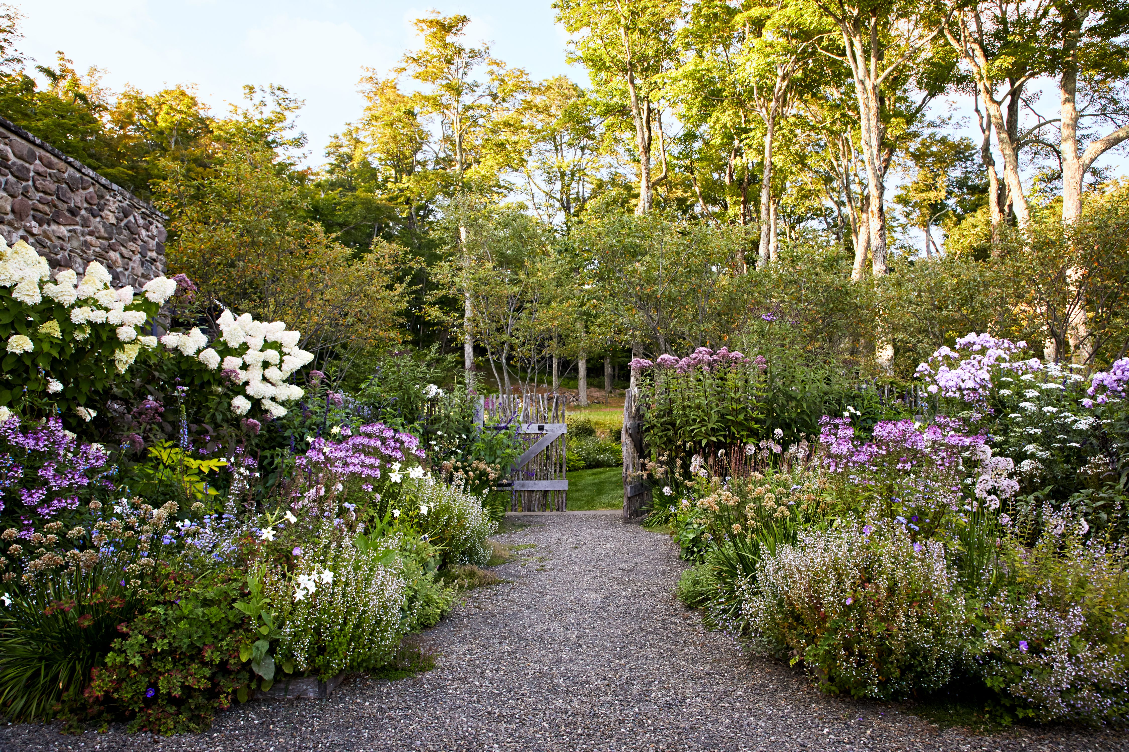 Gardener working in a colourful English garden
